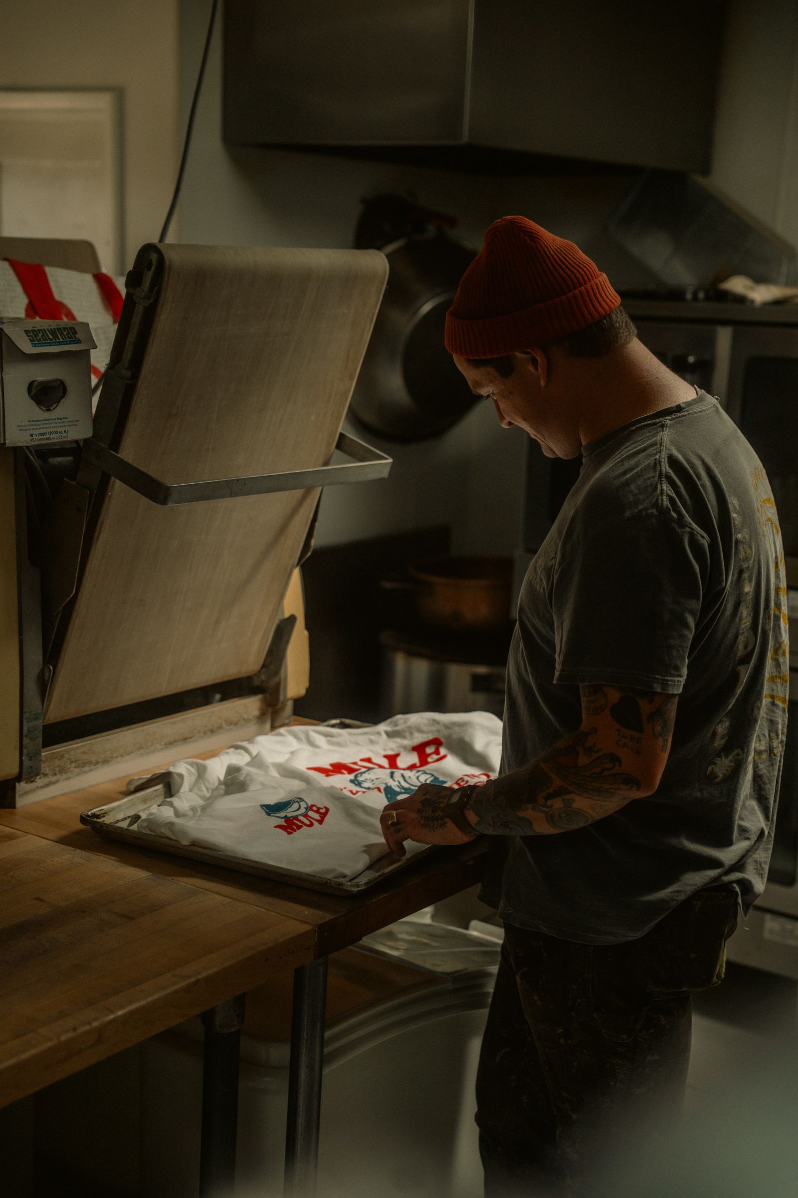 A print-on-demand operator preparing a printed shirt