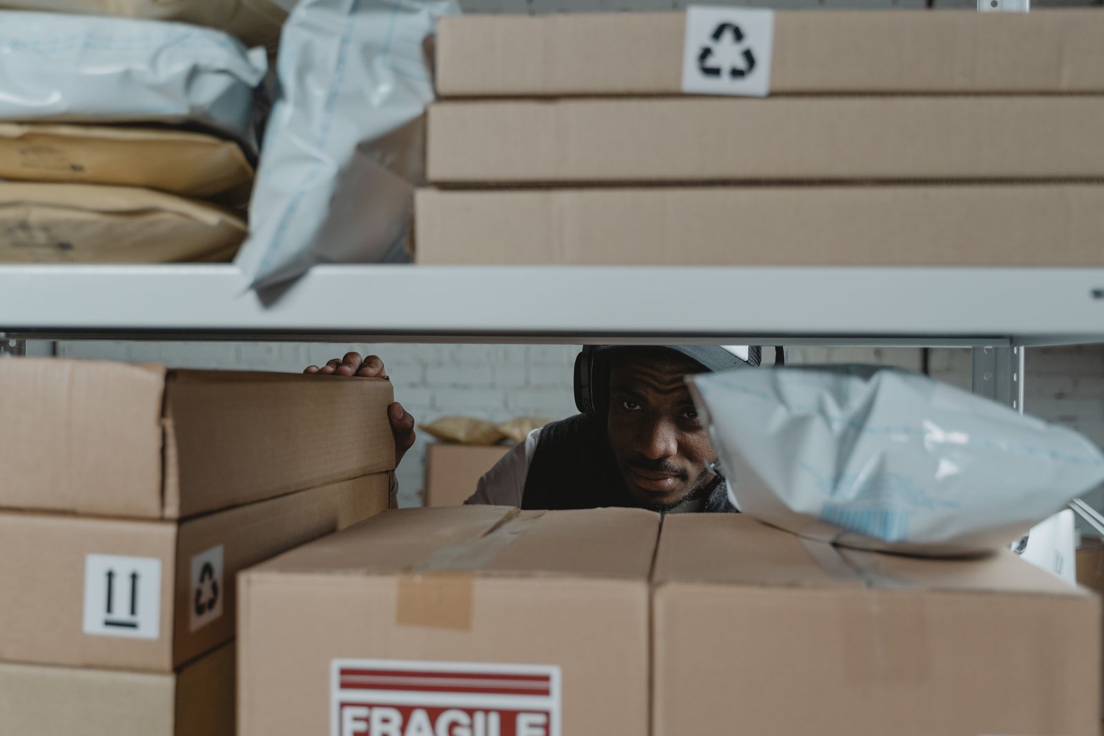 A warehouse worker inspecting stored parcels